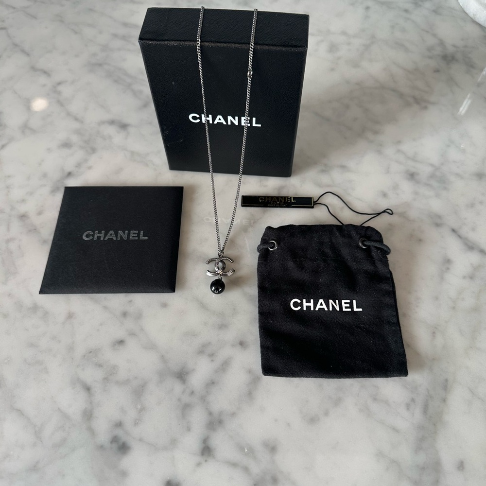 $650 CHANEL NWT Silver and Black Pendant Necklace in new condition.